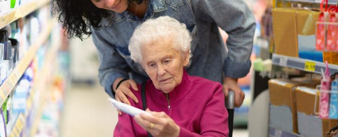 Caregiver with elderly client in a store