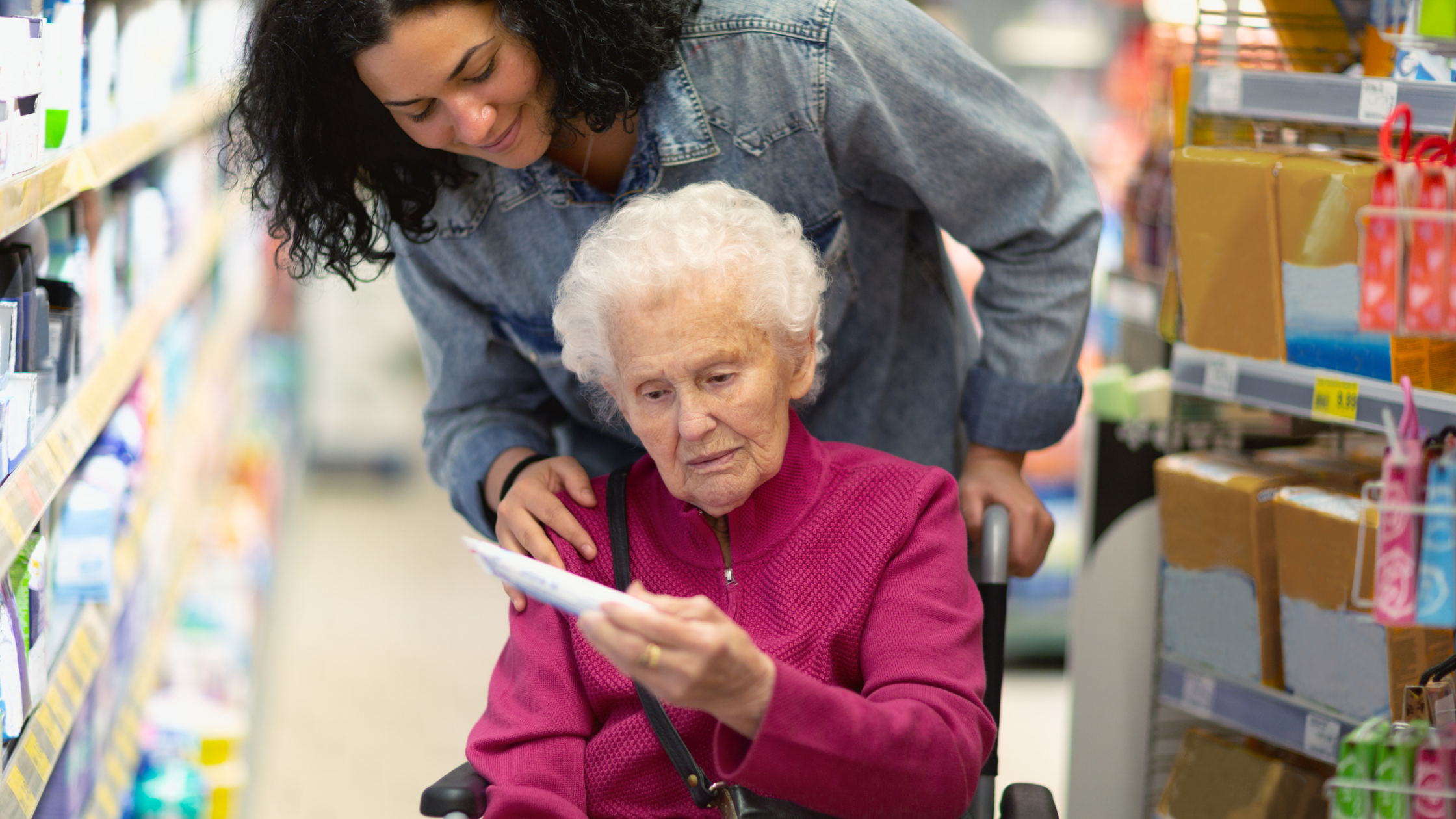 Caregiver with elderly client in a store