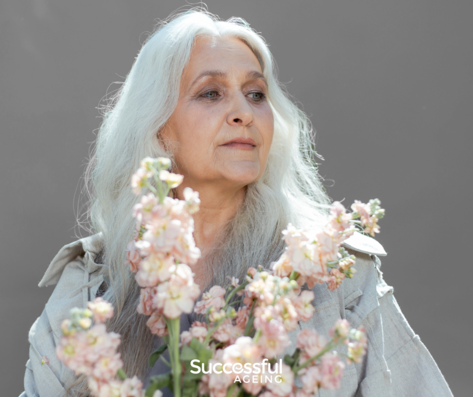 Beautiful older woman holding flowers